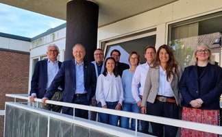 Das Bild zeigt mehrere Innenstadtakteure in Peine, die auf einem Balkon stehen. 